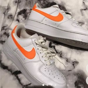 Orange and white Nike Air Force ones